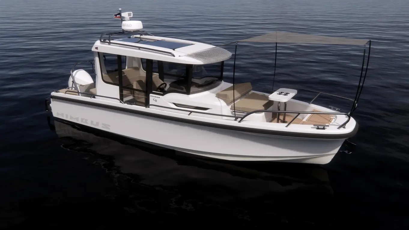 Nimbus C8 boat with a sleek design rests on calm waters, featuring seating, a sunshade, and a visible flag on the roof.